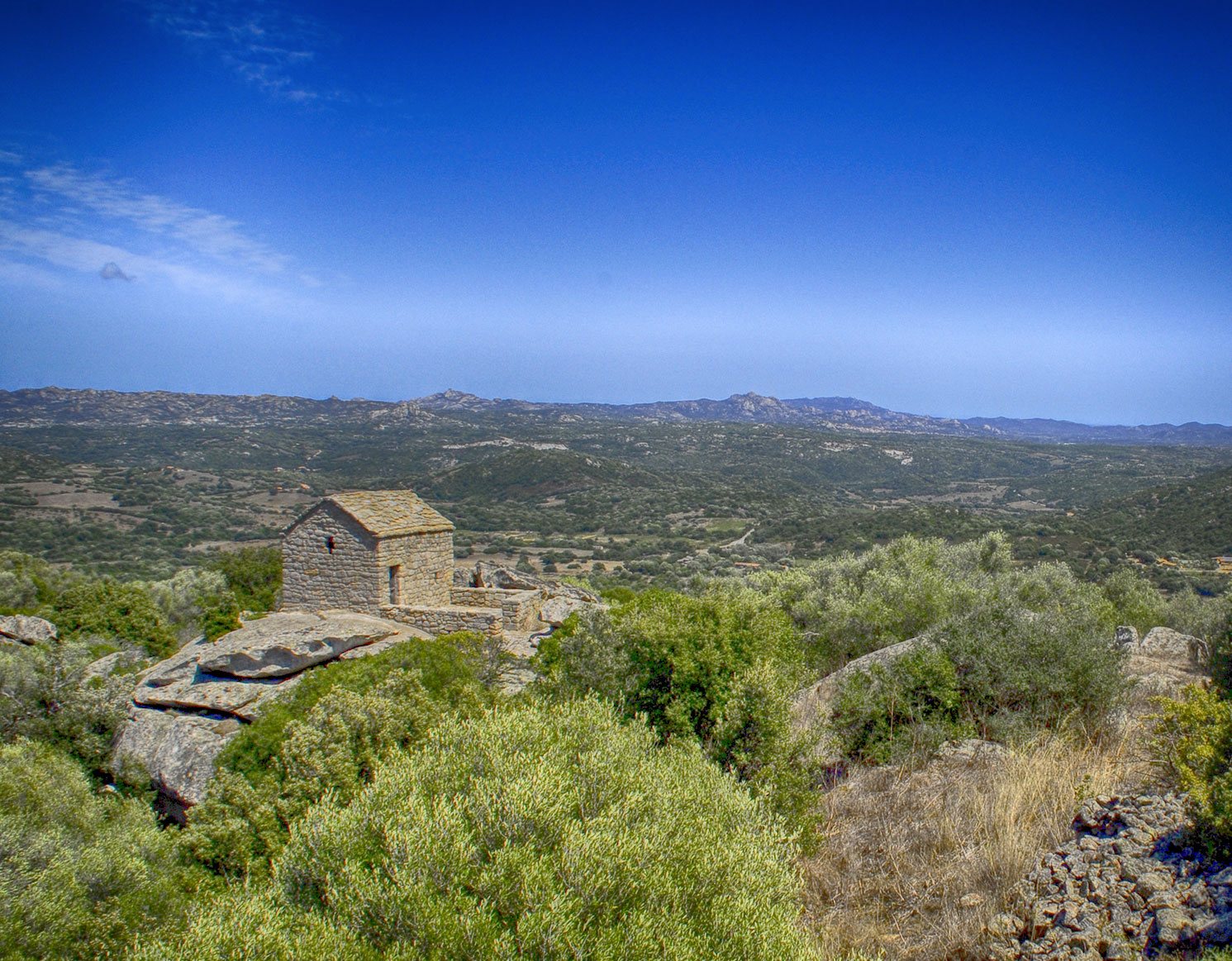 Small stone church overlooking the hills of Gallura, Sardinia